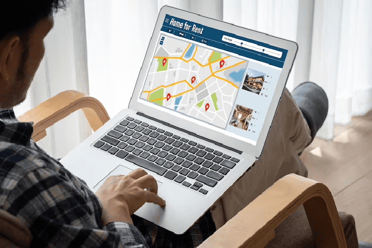 Man checking the map for rental homes on his laptop 